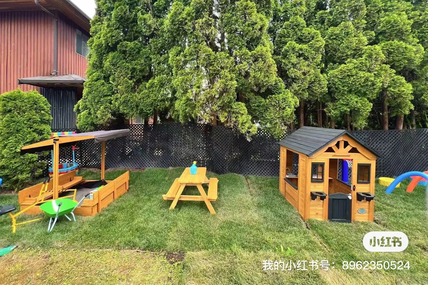 Enclosed backyard with playhouse